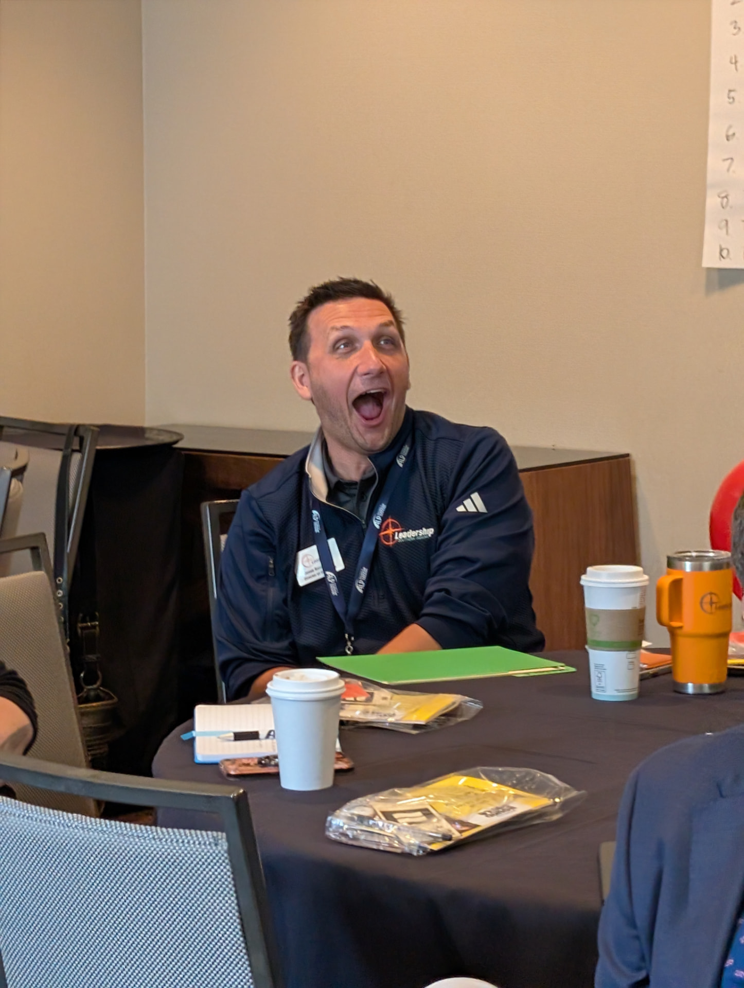 A player laughing at the table during a session.